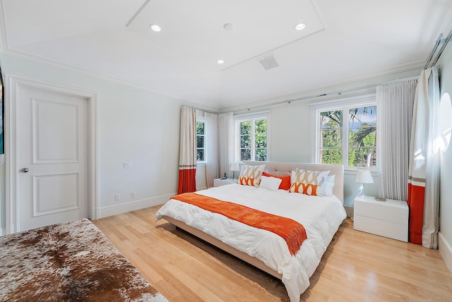 bedroom with lofted ceiling and light hardwood / wood-style flooring