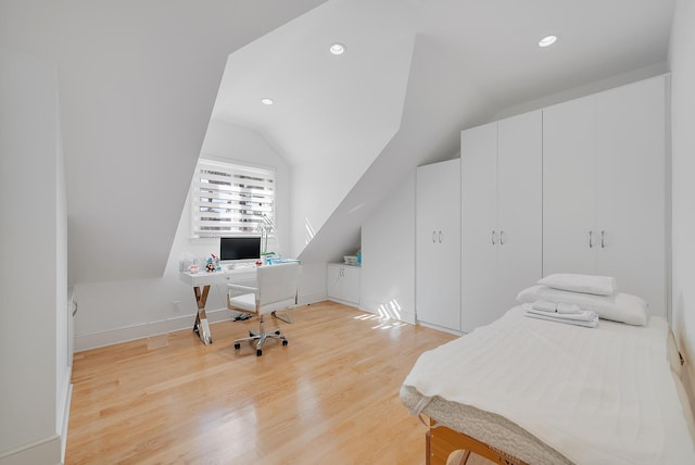 bedroom featuring lofted ceiling and light hardwood / wood-style floors