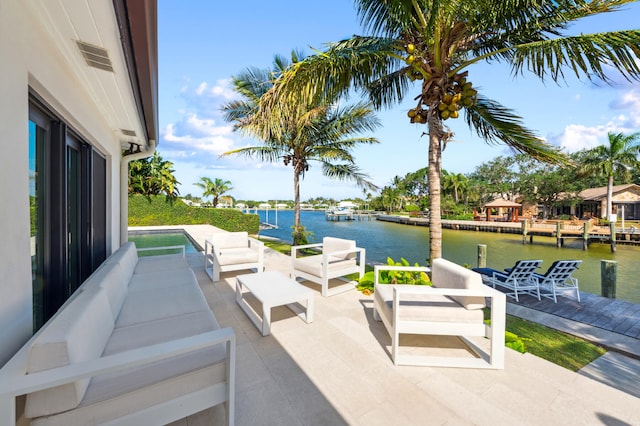 view of patio / terrace featuring an outdoor living space, a dock, and a water view