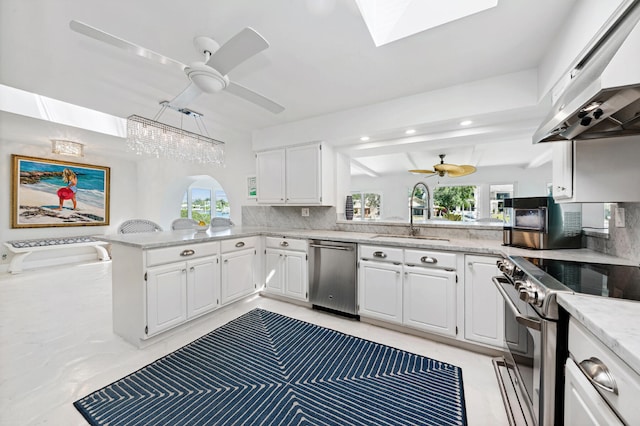 kitchen with kitchen peninsula, exhaust hood, white cabinetry, sink, and stainless steel appliances