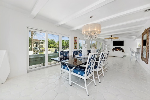 dining area with beam ceiling, ceiling fan with notable chandelier, and a wealth of natural light