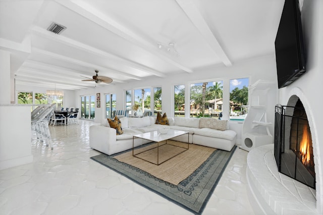 living room featuring ceiling fan and beamed ceiling