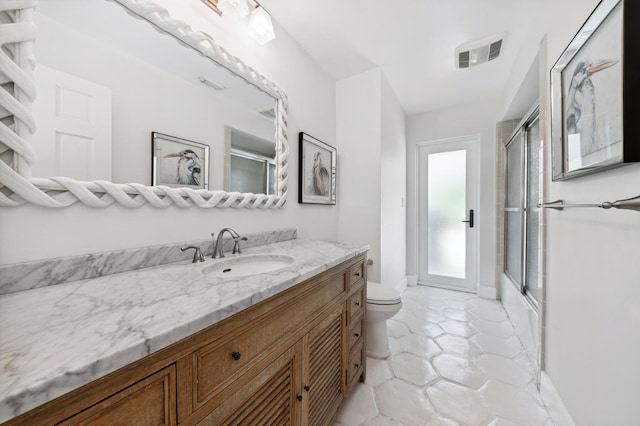 full bathroom with vanity, toilet, and shower / bath combination with glass door