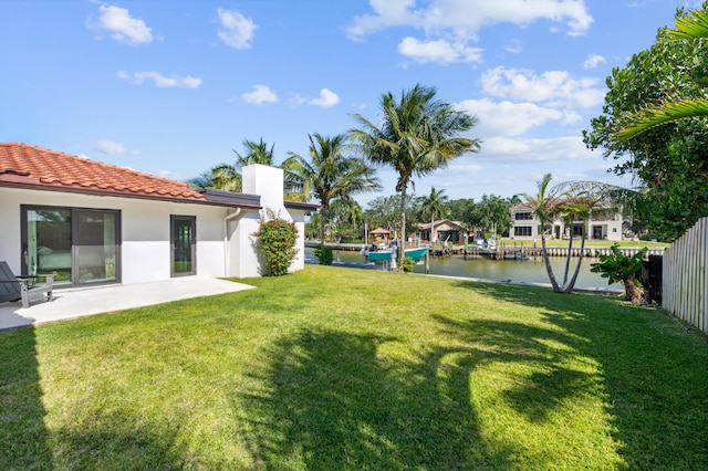 view of yard featuring a water view and a patio area