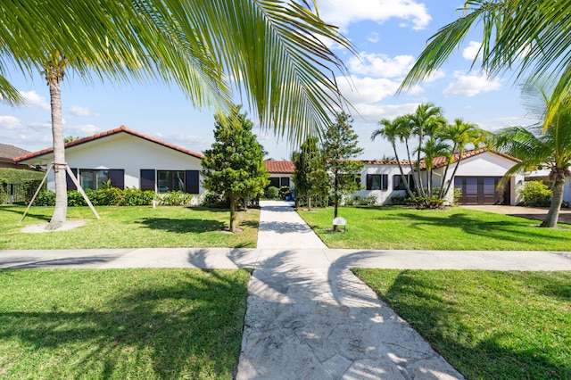 view of front of property with a front yard and a garage