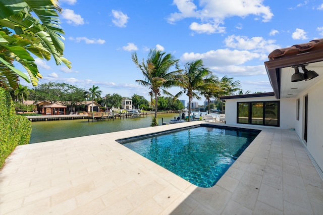 view of pool featuring a patio and a water view