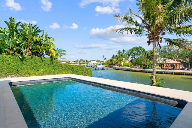 view of swimming pool featuring a water view