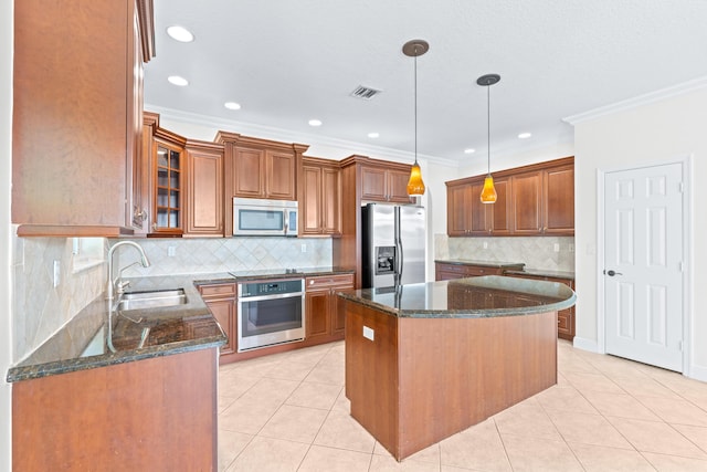 kitchen featuring a center island, hanging light fixtures, appliances with stainless steel finishes, and dark stone counters