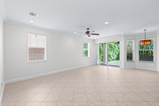 spare room featuring crown molding, light tile patterned floors, and ceiling fan