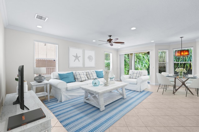 tiled living room featuring ceiling fan and crown molding