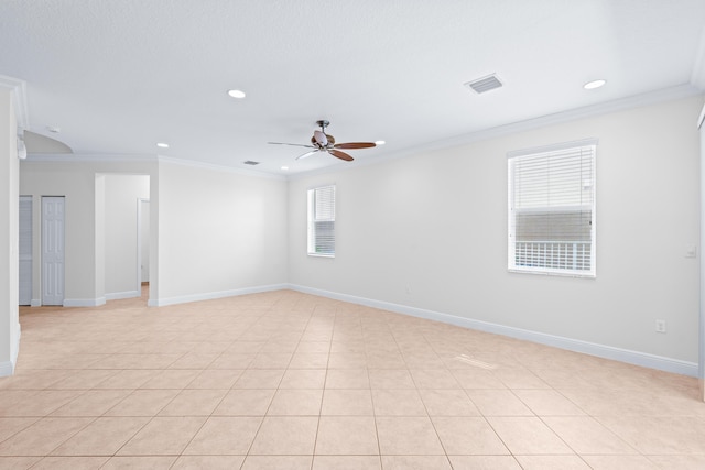 tiled spare room with ceiling fan and ornamental molding