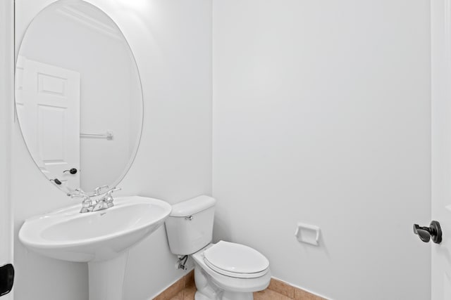 bathroom featuring tile patterned floors, toilet, and ornamental molding