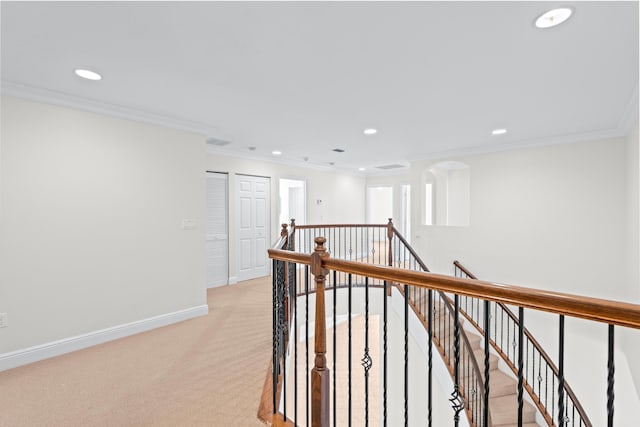 hallway with light carpet and ornamental molding