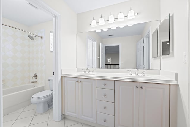 full bathroom with tile patterned flooring, vanity, toilet, and tiled shower / bath