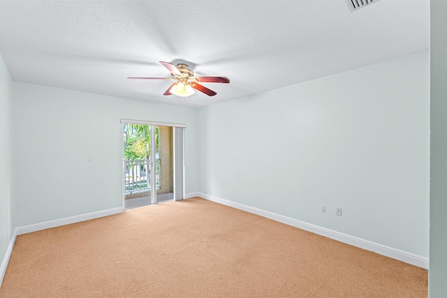 empty room with carpet, ceiling fan, and a textured ceiling