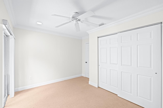 unfurnished bedroom featuring light carpet, a closet, ceiling fan, and ornamental molding