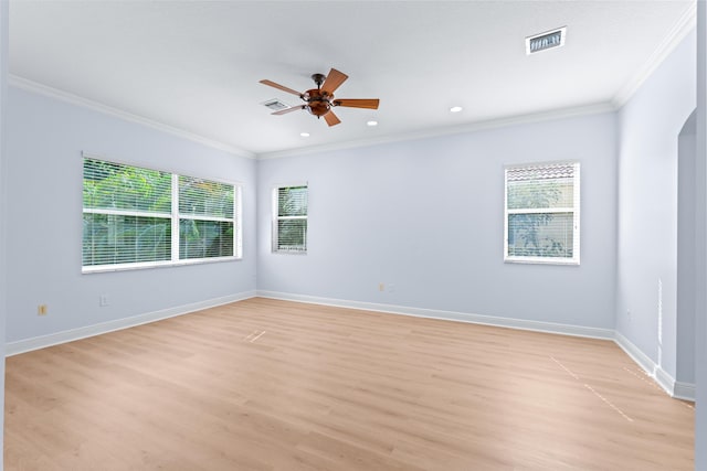 spare room with light wood-type flooring, ceiling fan, and crown molding