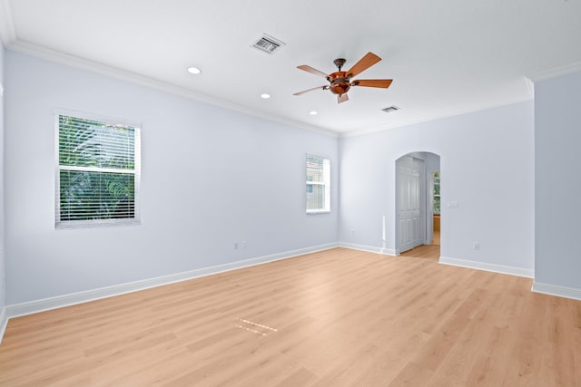 empty room with light wood-type flooring, plenty of natural light, and ornamental molding