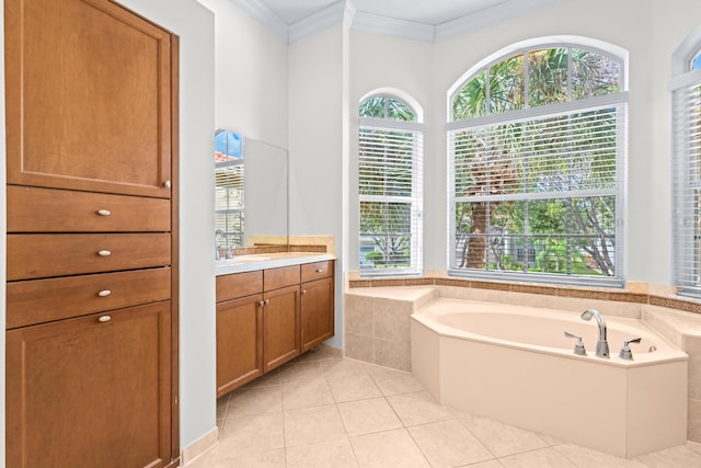 bathroom featuring tile patterned flooring, vanity, crown molding, and tiled tub