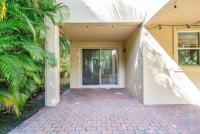 entrance to property featuring a patio area