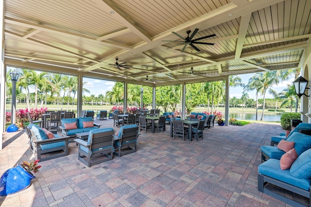 view of patio featuring an outdoor hangout area, a water view, and ceiling fan