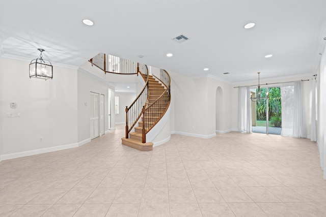 interior space featuring ornamental molding, light tile patterned floors, and an inviting chandelier