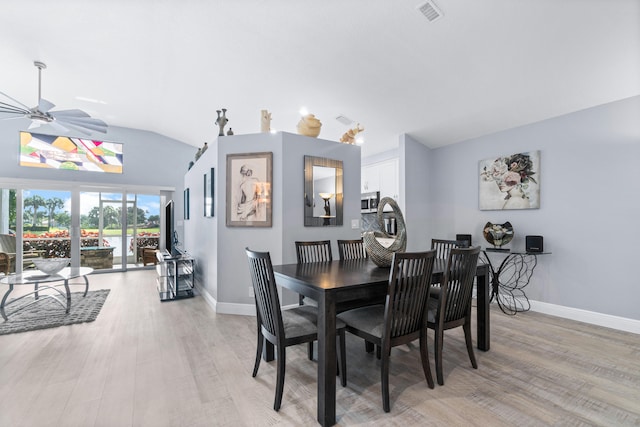 dining area featuring light wood-type flooring, lofted ceiling, and ceiling fan