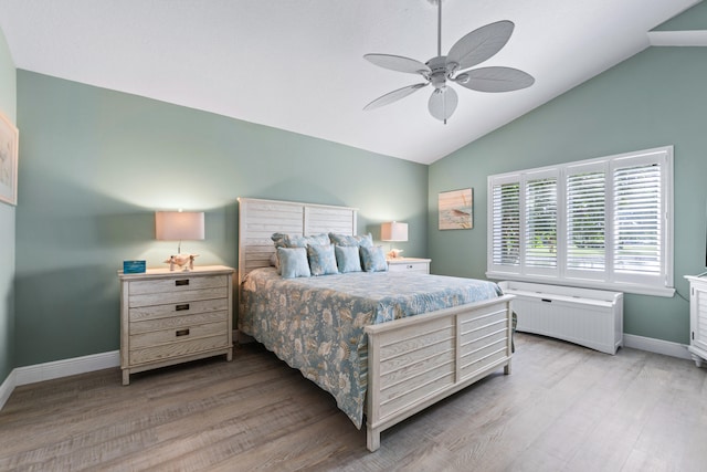 bedroom with lofted ceiling, ceiling fan, and light hardwood / wood-style flooring