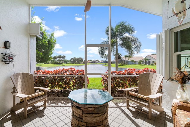 sunroom with a wealth of natural light and a water view