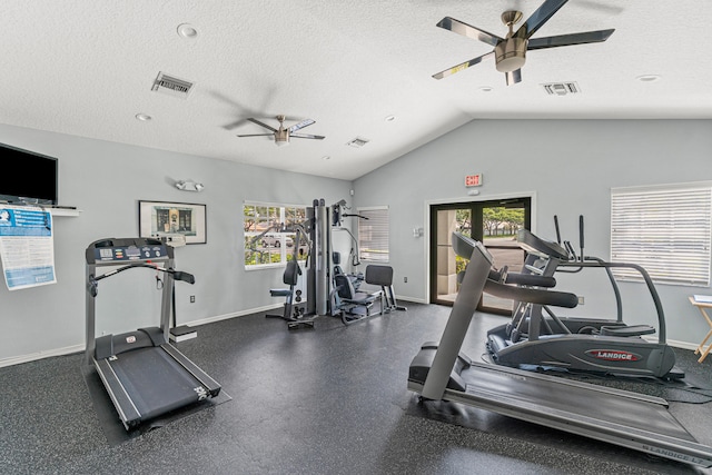 exercise room with ceiling fan, a healthy amount of sunlight, a textured ceiling, and lofted ceiling