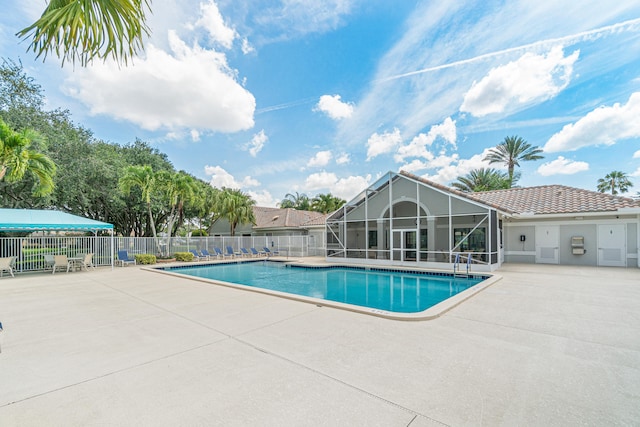 view of pool with a lanai and a patio