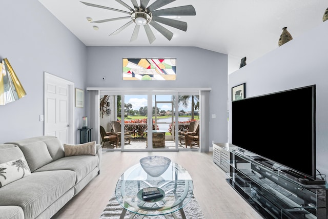 living room with ceiling fan, vaulted ceiling, and light hardwood / wood-style floors