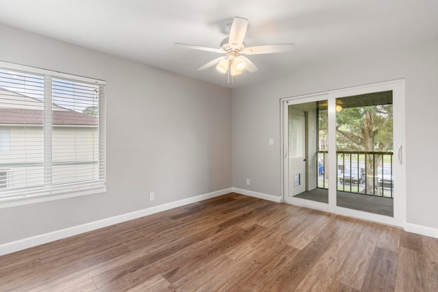 empty room with dark wood-type flooring and ceiling fan