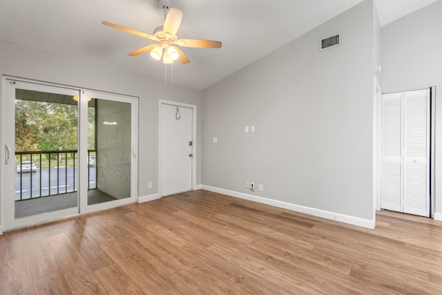 spare room with ceiling fan, vaulted ceiling, and light hardwood / wood-style flooring