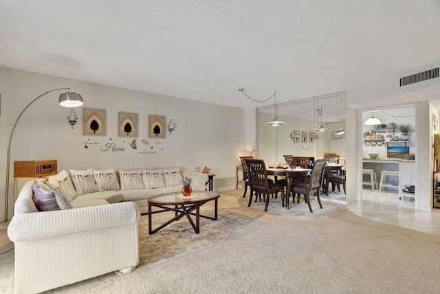 living room with light carpet and a textured ceiling