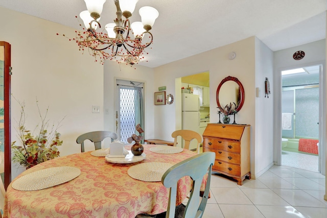 dining space featuring light tile patterned flooring and a chandelier