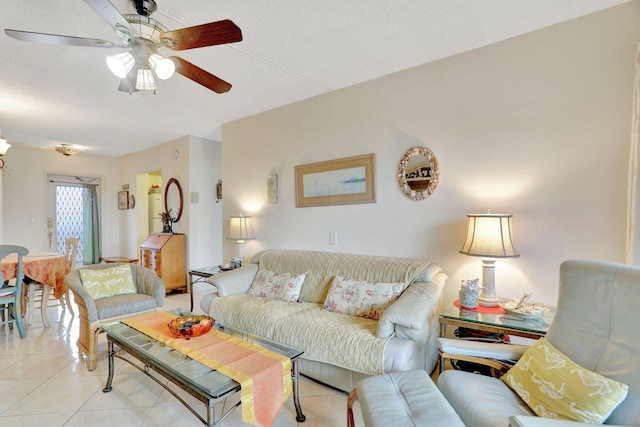 tiled living room with ceiling fan