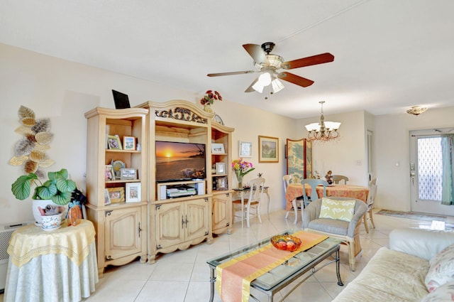 living room featuring ceiling fan with notable chandelier and light tile patterned floors