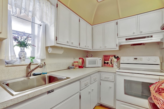 kitchen with white appliances, white cabinetry, sink, and lofted ceiling