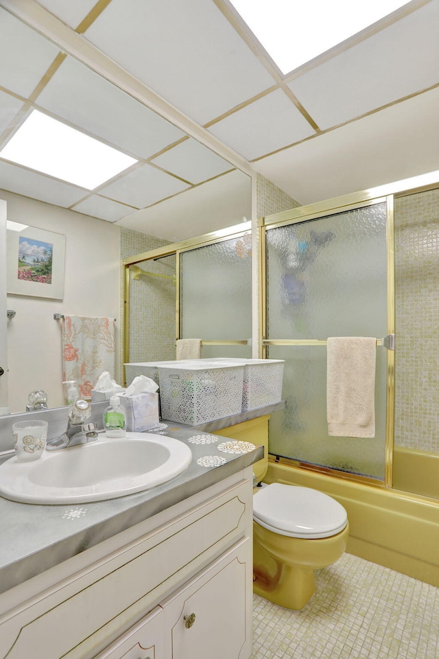 full bathroom featuring toilet, tile patterned floors, vanity, and enclosed tub / shower combo