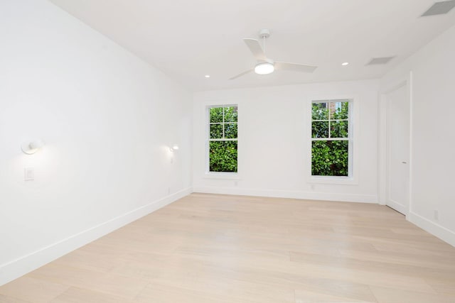 spare room featuring ceiling fan and light hardwood / wood-style flooring