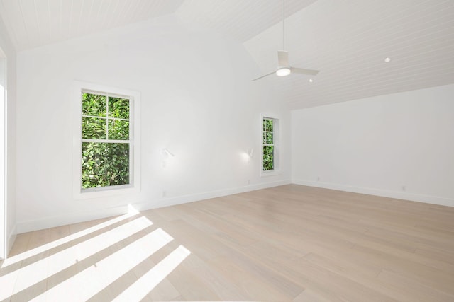 spare room with ceiling fan, light hardwood / wood-style floors, vaulted ceiling, and a healthy amount of sunlight