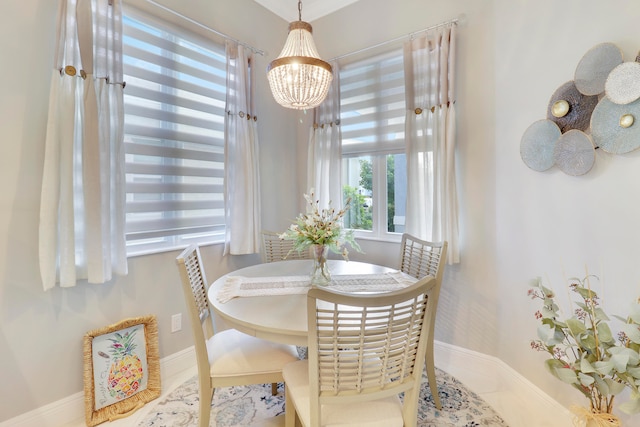 tiled dining area featuring a chandelier