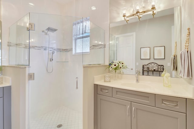 bathroom featuring walk in shower and vanity