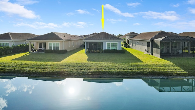 back of house featuring a patio, glass enclosure, and a lawn