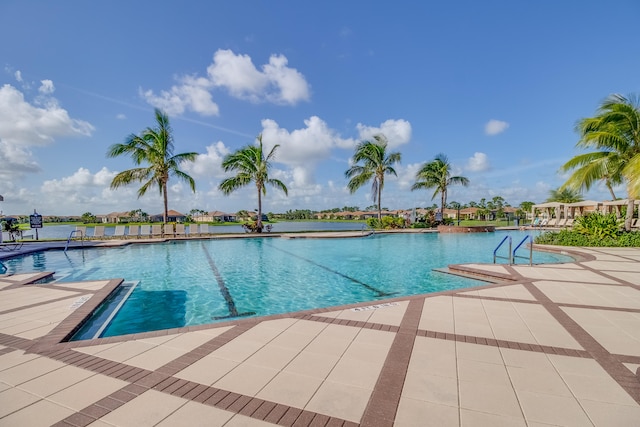 view of pool with a patio and a water view