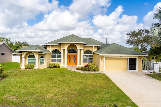 view of front of house with a front lawn and a garage