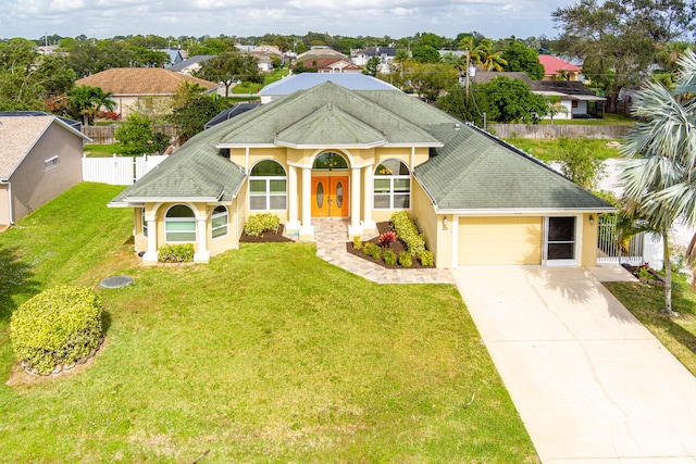 view of front facade with a front yard and a garage