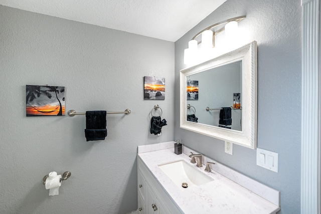 bathroom with vanity and a textured ceiling