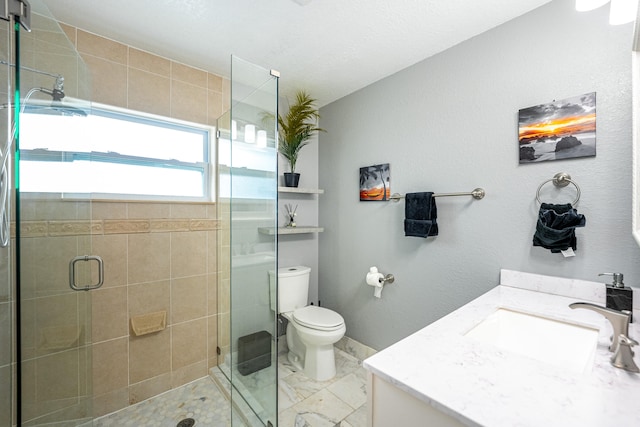 bathroom with vanity, toilet, and walk in shower